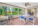 Enclosed lanai with plenty of seating, a ceiling fan, and view of back yard and home at 3016 Mango Tree Dr, Edgewater, FL 32141