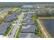 Overhead image featuring community pools, water views, manicured landscaping, and nearby trees at 3219 Modena Way, New Smyrna Beach, FL 32168