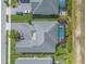Overhead view of a property showcasing a private pool, lush landscaping, and driveway at 3219 Modena Way, New Smyrna Beach, FL 32168
