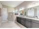 Beautiful primary bath with double vanity, granite counters and glass enclosed shower at 3219 Modena Way, New Smyrna Beach, FL 32168