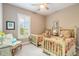 Charming bedroom with twin beds, a chair, and a window with shutters at 3219 Modena Way, New Smyrna Beach, FL 32168