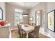 Bright dining room with natural light, modern decor, and seating for six at 3219 Modena Way, New Smyrna Beach, FL 32168