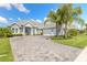 Beautifully landscaped single-Gathering home with paver driveway and lush tropical landscaping at 3219 Modena Way, New Smyrna Beach, FL 32168