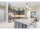 Open kitchen features a large island with seating, stainless appliances, and pendant lights at 3219 Modena Way, New Smyrna Beach, FL 32168