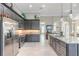 Contemporary kitchen with stainless steel appliances, island seating, and open floor plan at 3219 Modena Way, New Smyrna Beach, FL 32168