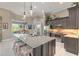 Well-appointed kitchen featuring granite countertops, stainless steel appliances, and decorative pendant lighting at 3219 Modena Way, New Smyrna Beach, FL 32168