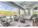 Beautiful screened-in lanai with ample seating, stylish decor, and views of the sparkling pool and backyard at 3219 Modena Way, New Smyrna Beach, FL 32168