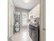 Clean laundry room with white cabinets, modern appliances, and ample storage space for convenience at 3219 Modena Way, New Smyrna Beach, FL 32168