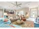 Open living room boasts a tray ceiling, fan, neutral color palette and an area rug at 3219 Modena Way, New Smyrna Beach, FL 32168