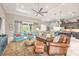 Open living room features a ceiling fan, stylish furniture, and access to the kitchen at 3219 Modena Way, New Smyrna Beach, FL 32168