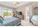 Serene main bedroom with an ensuite bathroom, ceiling fan, and sliding glass door to the outdoor pool at 3219 Modena Way, New Smyrna Beach, FL 32168