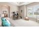 Office area with a decorative light fixture, neutral carpet, and a large window at 3219 Modena Way, New Smyrna Beach, FL 32168