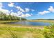 Scenic view of a tranquil pond surrounded by lush greenery, offering a peaceful setting at 3219 Modena Way, New Smyrna Beach, FL 32168