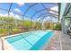 Enjoy a refreshing dip in this beautiful pool surrounded by a screened enclosure and lush landscaping at 3219 Modena Way, New Smyrna Beach, FL 32168