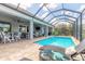 Relax by the screened-in pool with an inviting outdoor living space, ideal for entertaining and leisure at 3219 Modena Way, New Smyrna Beach, FL 32168