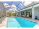 Screened-in pool area with an expansive deck and ample seating at 3219 Modena Way, New Smyrna Beach, FL 32168