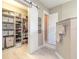 Well-organized walk-in closet with custom shelving and sliding barn door at 3219 Modena Way, New Smyrna Beach, FL 32168