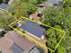 Aerial view of property with yellow outline surrounded by mature trees and neighboring properties at 3349 Glenshane Way, Ormond Beach, FL 32174