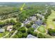 Aerial view of the community golf course with clubhouse and parking lot, arrow indicates subject property at 3349 Glenshane Way, Ormond Beach, FL 32174
