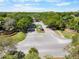 Aerial view of the Halifax Plantation neighborhood entrance, showcasing mature trees, landscaping, and neighborhood signage at 3349 Glenshane Way, Ormond Beach, FL 32174