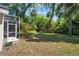 Spacious and serene backyard with mature trees and lawn, perfect for outdoor activities at 3349 Glenshane Way, Ormond Beach, FL 32174