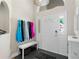 Bright entryway with white accents, a storage cabinet, bench seating, and decorative lighting fixture at 3349 Glenshane Way, Ormond Beach, FL 32174