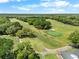 Scenic aerial view of the lush green golf course with mature trees and well-manicured fairways at 3349 Glenshane Way, Ormond Beach, FL 32174