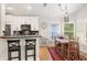 Bright kitchen with stainless steel appliances, modern bar seating, and cozy dining area at 3349 Glenshane Way, Ormond Beach, FL 32174
