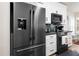 Modern kitchen featuring stainless steel appliances and white cabinets at 3349 Glenshane Way, Ormond Beach, FL 32174