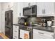 Modern kitchen featuring stainless steel appliances and white cabinets at 3349 Glenshane Way, Ormond Beach, FL 32174