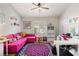 Home office with a pink couch, unique floral rug, and a functional desk setup with lots of shelving at 3349 Glenshane Way, Ormond Beach, FL 32174