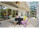 Enjoy the covered patio with an outdoor ceiling fan and colorful seating arrangement at 3349 Glenshane Way, Ormond Beach, FL 32174