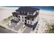 Aerial view of a three-story home that features an abundance of balconies and a two-car garage at 3403 S Atlantic Ave # 3, New Smyrna Beach, FL 32169