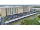 Close aerial of Admiralty Club exterior and parking area, showing architectural details and covered parking at 3606 S Peninsula Dr # 509, Port Orange, FL 32127