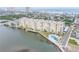 Aerial view of waterfront condo building with outdoor pool and beautiful dock at 3606 S Peninsula Dr # 509, Port Orange, FL 32127