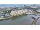 This aerial view shows the condo community's waterfront access, boat docks, and coastal city views at 3606 S Peninsula Dr # 509, Port Orange, FL 32127