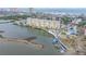 This aerial view showcases the waterfront condo building, pool, and docks on the waterway at 3606 S Peninsula Dr # 509, Port Orange, FL 32127