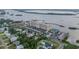 Expansive aerial view of Admiralty Club condos nestled along the river, showcasing the building, parking, and waterfront location at 3606 S Peninsula Dr # 509, Port Orange, FL 32127