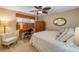 This bedroom features a ceiling fan, a desk, and ample closet space for a comfortable and functional living space at 3606 S Peninsula Dr # 509, Port Orange, FL 32127