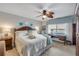 Cozy bedroom with comfortable furniture, water views, and a ceiling fan at 3606 S Peninsula Dr # 509, Port Orange, FL 32127