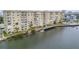 Waterfront condo building boasting private balconies, manicured lawn, and serene water views at 3606 S Peninsula Dr # 509, Port Orange, FL 32127