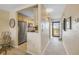 Condo hallway with neutral tones, leading to the kitchen and entrance at 3606 S Peninsula Dr # 509, Port Orange, FL 32127
