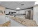 Bright kitchen with granite countertops, stainless appliances, and ample cabinet space at 3606 S Peninsula Dr # 509, Port Orange, FL 32127