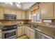 Updated kitchen featuring stainless steel appliances, granite countertops, and stylish backsplash at 3606 S Peninsula Dr # 509, Port Orange, FL 32127
