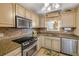 Bright kitchen with stainless steel appliances, stone countertops, tile backsplash, and floral accents at 3606 S Peninsula Dr # 509, Port Orange, FL 32127