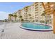 A pristine community pool offers waterfront views of this desirable condo complex at 3606 S Peninsula Dr # 509, Port Orange, FL 32127
