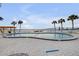 A bright and airy community pool surrounded by palm trees offers a waterfront view at 3606 S Peninsula Dr # 509, Port Orange, FL 32127