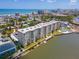 Aerial view showcases the condo building, surrounding cityscape and waterfront views at 3606 S Peninsula Dr # 703, Port Orange, FL 32127