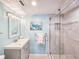Light and bright bathroom features a gray vanity and tiled walk-in shower at 3606 S Peninsula Dr # 703, Port Orange, FL 32127
