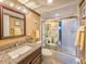 Bathroom showcasing granite counters and a shower-tub combo with decorative door at 3606 S Peninsula Dr # 703, Port Orange, FL 32127